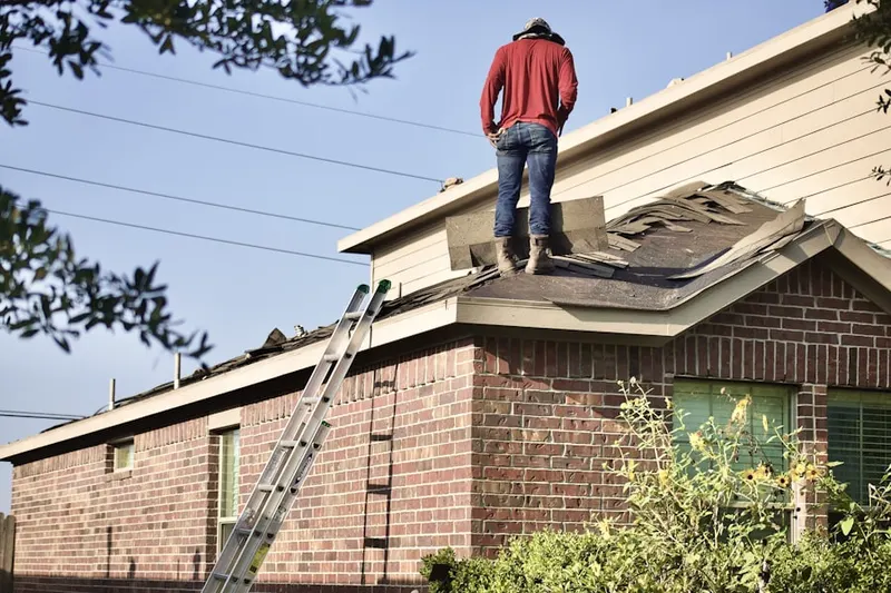 Professional roofer working on a residential roof in Hopkins